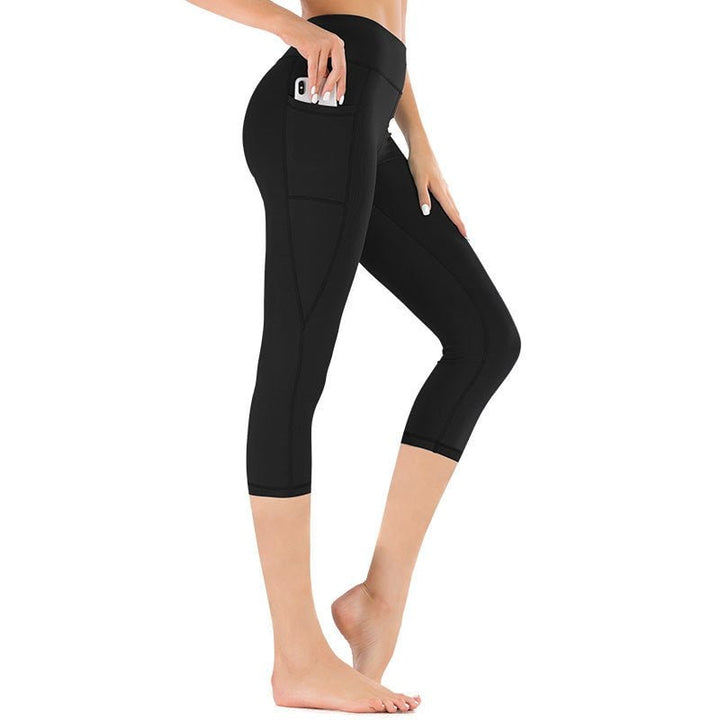 Leggings capri da donna a vita alta neri con tasche laterali per yoga, fitness e allenamento.