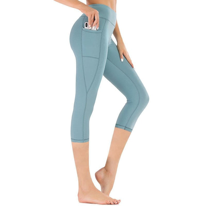 Activewear capri da donna a vita alta con tasche, perfetti per yoga, fitness e uso quotidiano.