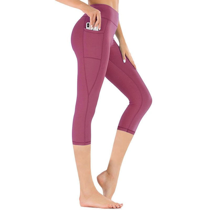 Leggings capri da donna in tessuto traspirante a vita alta con tasche, per sport e massimo comfort.