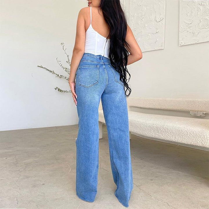 Pantaloni jeans donna trendy a vita alta, vestibilità ampia con gamba larga, dettagli strappati e orlo sfrangiato.
