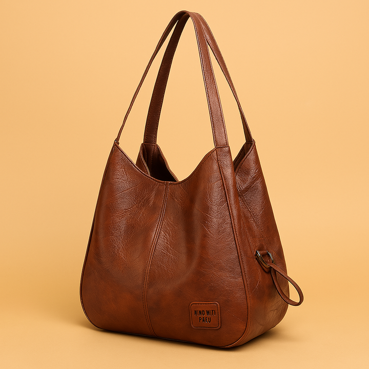 Borsa a tracolla hobo da donna in ecopelle morbida con patchwork geometrico. Stile casual ed elegante.