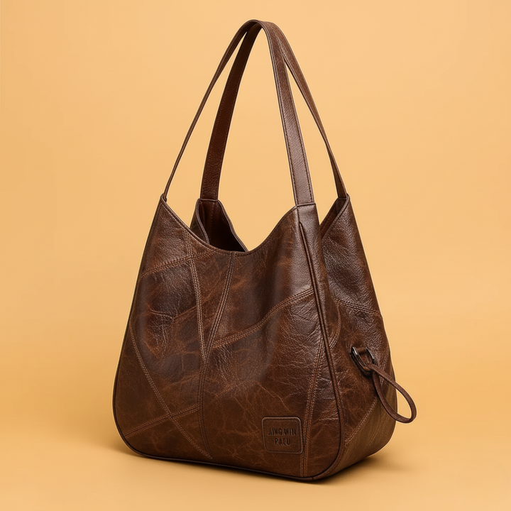 Borsa a tracolla hobo da donna in ecopelle con motivo patchwork geometrico. Ideale per eleganza quotidiana.