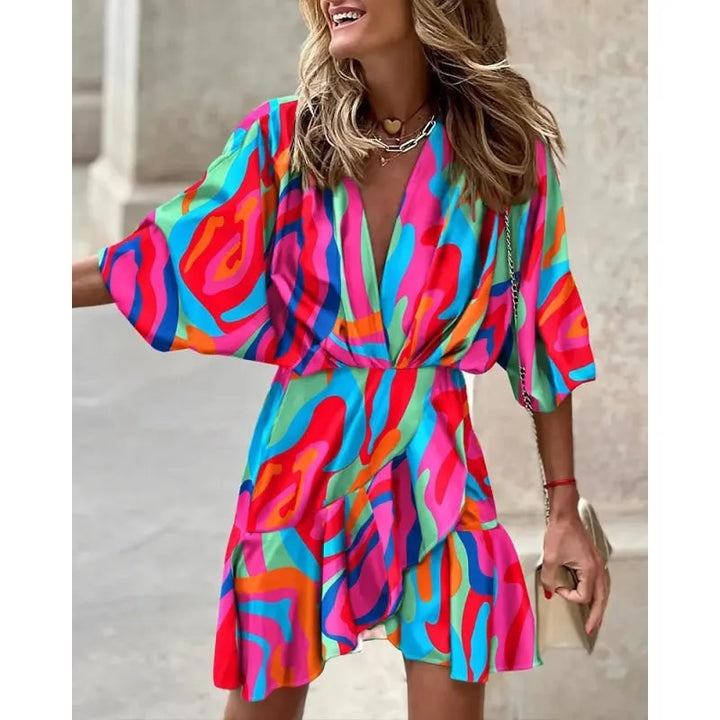 Abito da cerimonia donna con gonna a portafoglio, volant e stampa floreale. Mini vestito versatile per eventi.