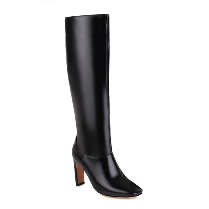 Primo piano stivali donna al ginocchio, punta quadrata e tacco grosso. Calzature eleganti e moderne per moda autunno inverno.