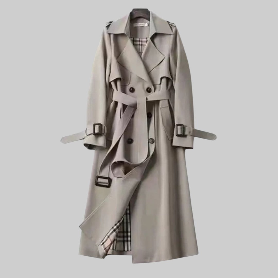 Trench da donna lungo e raffinato, con design doppiopetto e cintura che valorizza la figura. Ideale per ogni stile.