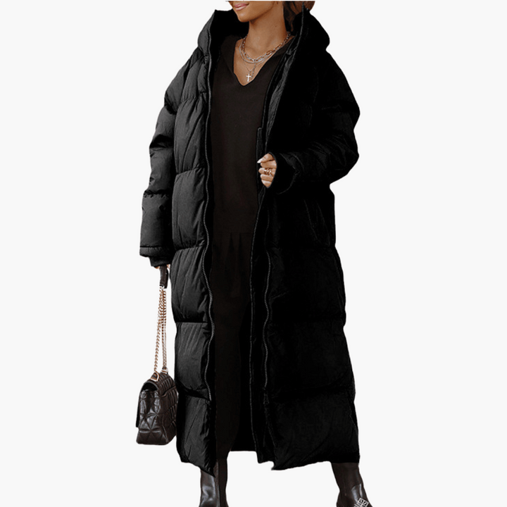Cappotto piumino donna lungo trapuntato con cappuccio, ideale per l'inverno. Caldo, comodo e di moda donna.