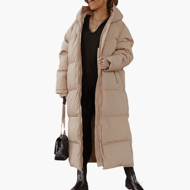 Giacca invernale da donna, piumino lungo trapuntato con cappuccio. Perfetta per uno stile casual e l'inverno.
