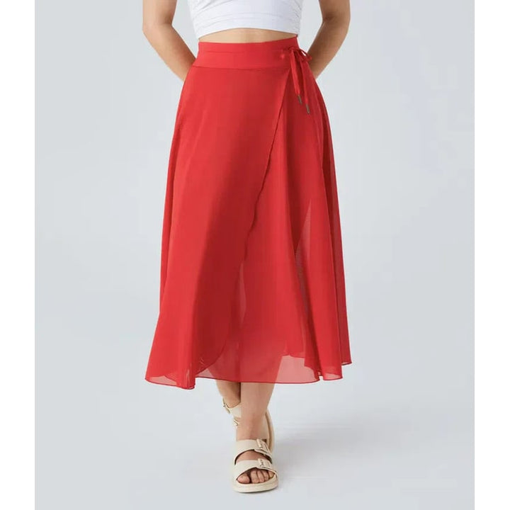 Gonna donna velata midi a portafoglio. Vita alta, stile A-line. Eleganza trasparente per ogni occasione.