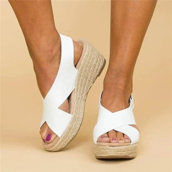 Sandali con zeppa da donna, design con cinturino incrociato e punta aperta. Perfetti per outfit estivi.