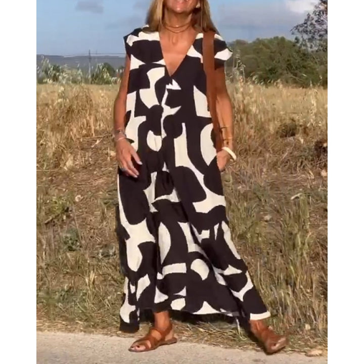 Vestito estivo maxi donna, fantasia vibrante, maniche ad aletta, scollo a V. Perfetto per vacanze al mare.