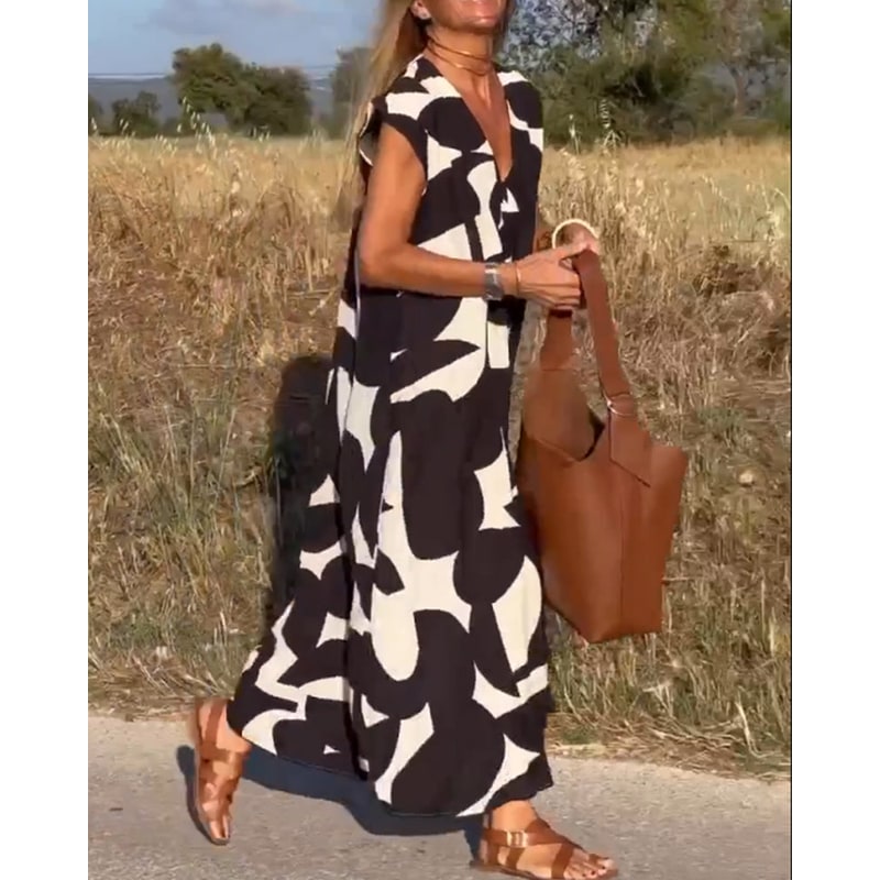 Vestito maxi con scollo a V e maniche ad aletta, fantasia estiva per donna. Look comodo, trendy e chic.