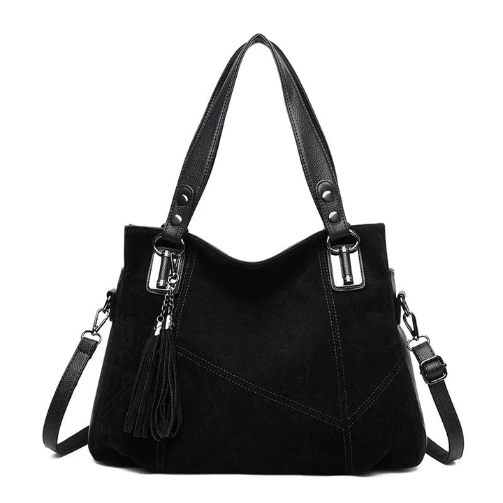 Borsa a spalla da donna vista frontale, design strutturato in pelle martellata e camoscio.