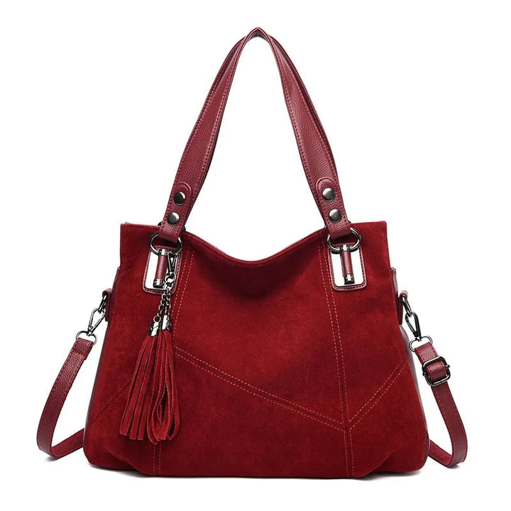 Dettaglio texture borsa strutturata: pelle martellata e camoscio. Finitura premium per la moda donna.