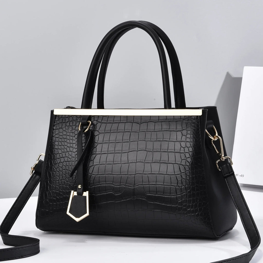 Borsa strutturata donna in pelle di coccodrillo, raffinata e versatile, con manici e tracolla.