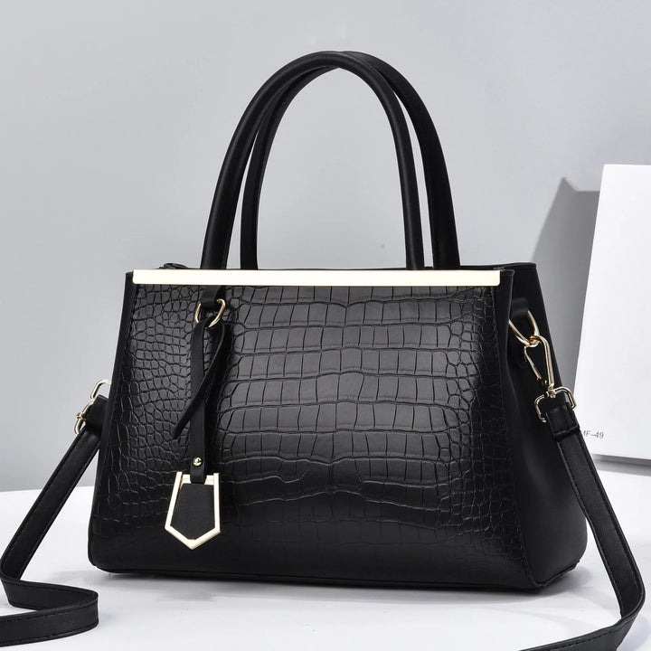 Borsa strutturata donna in pelle di coccodrillo, raffinata e versatile, con manici e tracolla.