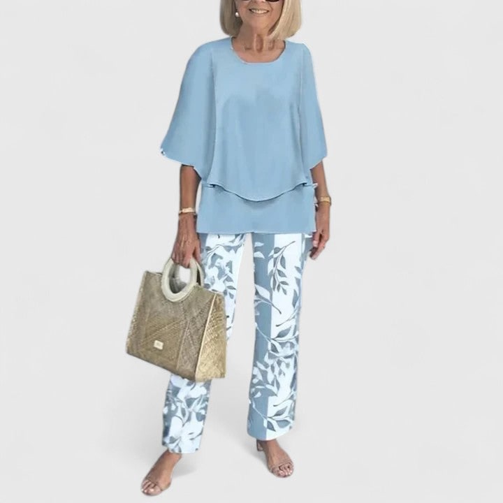 Elegante completo donna due pezzi: tunica a strati con collo rotondo e pantaloni dritti. Stile versatile.