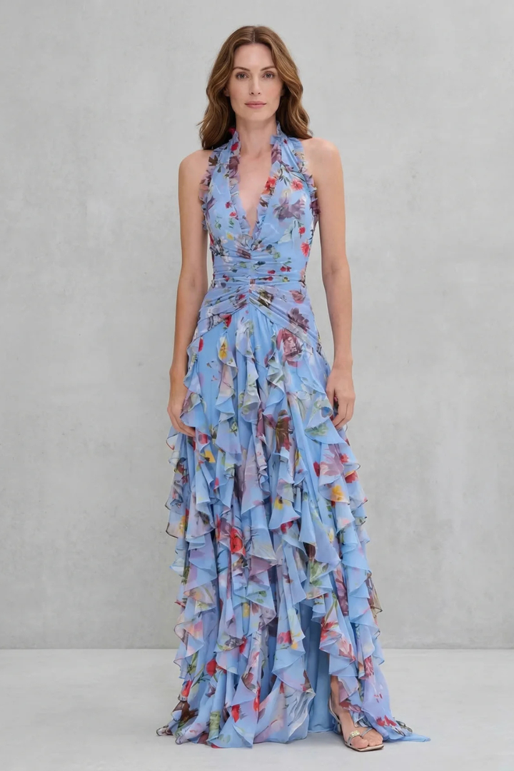 Splendido abito lungo estivo donna a fantasia floreale. Design con scollo all'americana e balze voluminose.