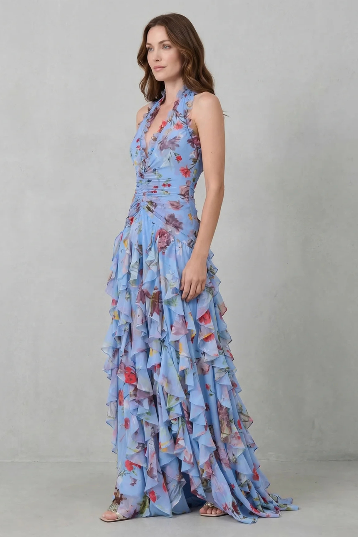 Trendy abito lungo donna estivo con stampa floreale, scollo all'americana e morbide balze per un look chic.