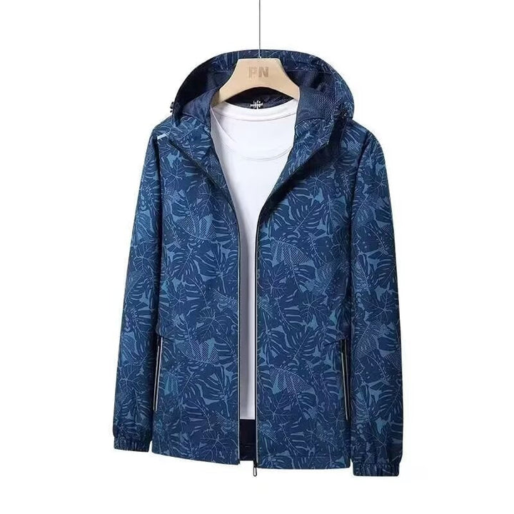 Abbigliamento sportivo donna: giacca a vento traspirante con stampa foglie e cappuccio, per corsa.